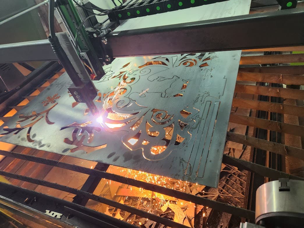 CNC plasma cutting steel plate on the shop table