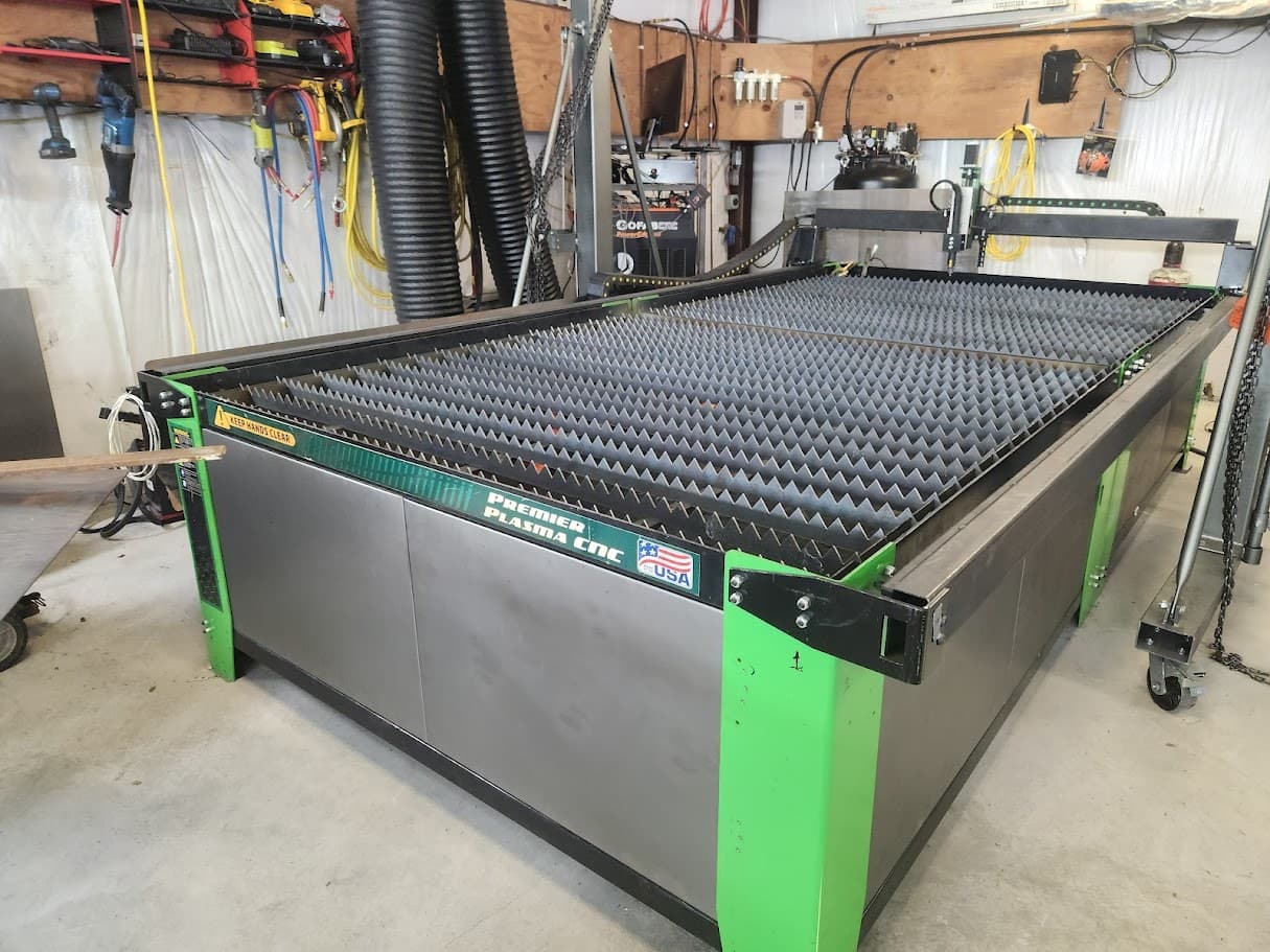 CNC plasma table and shop equipment staged for metal cutting